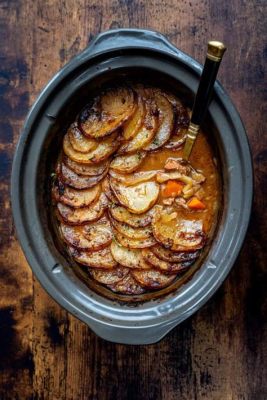  Lancashire Hotpot: A Hearty Symphony of Slow-Cooked Lamb and Rich Gravy Under a Crusty Potato Lid!